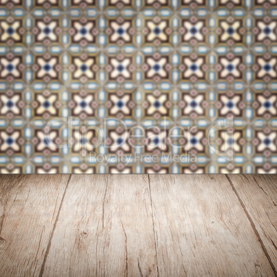 Wood table top and blur vintage ceramic tile pattern wall