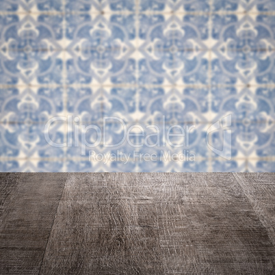 Wood table top and blur vintage ceramic tile pattern wall