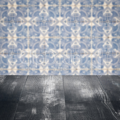 Wood table top and blur vintage ceramic tile pattern wall