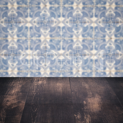 Wood table top and blur vintage ceramic tile pattern wall Wood table top and blur vintage ceramic tile pattern wall