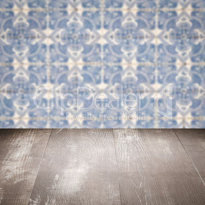 Wood table top and blur vintage ceramic tile pattern wall