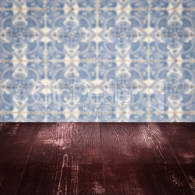 Wood table top and blur vintage ceramic tile pattern wall