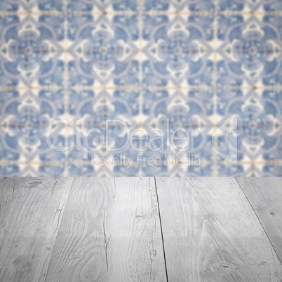 Wood table top and blur vintage ceramic tile pattern wall