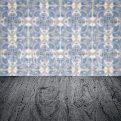 Wood table top and blur vintage ceramic tile pattern wall