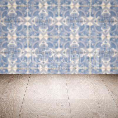 Wood table top and blur vintage ceramic tile pattern wall