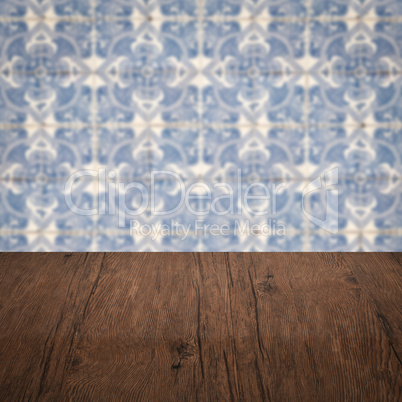 Wood table top and blur vintage ceramic tile pattern wall Wood table top and blur vintage ceramic tile pattern wall
