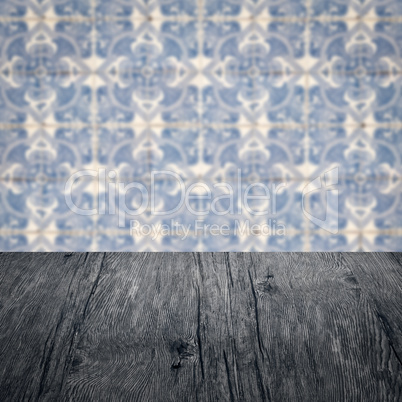 Wood table top and blur vintage ceramic tile pattern wall