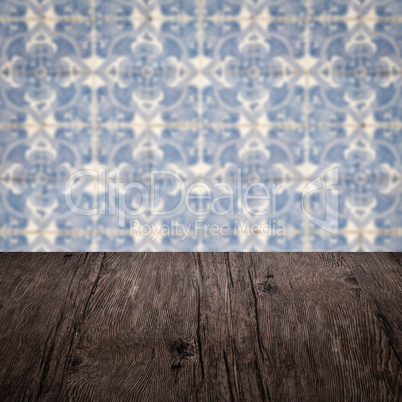 Wood table top and blur vintage ceramic tile pattern wall