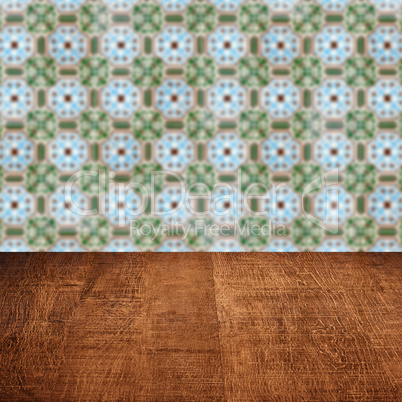 Wood table top and blur vintage ceramic tile pattern wall