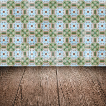 Wood table top and blur vintage ceramic tile pattern wall