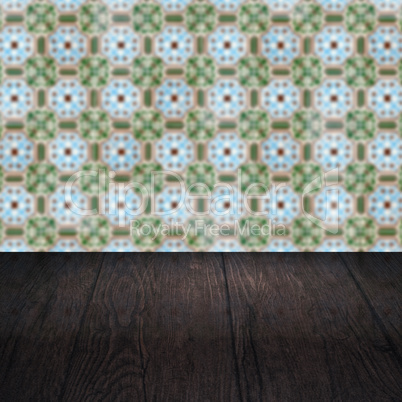 Wood table top and blur vintage ceramic tile pattern wall