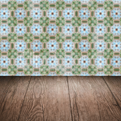 Wood table top and blur vintage ceramic tile pattern wall