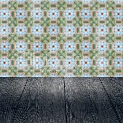 Wood table top and blur vintage ceramic tile pattern wall