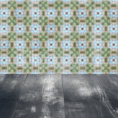 Wood table top and blur vintage ceramic tile pattern wall