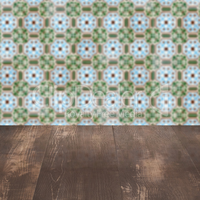 Wood table top and blur vintage ceramic tile pattern wall