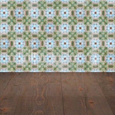 Wood table top and blur vintage ceramic tile pattern wall