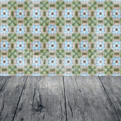 Wood table top and blur vintage ceramic tile pattern wall Wood table top and blur vintage ceramic tile pattern wall
