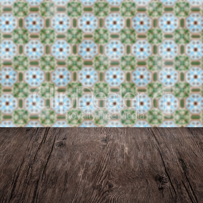 Wood table top and blur vintage ceramic tile pattern wall