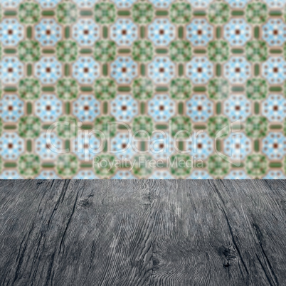 Wood table top and blur vintage ceramic tile pattern wall