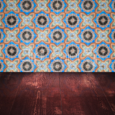 Wood table top and blur vintage ceramic tile pattern wall