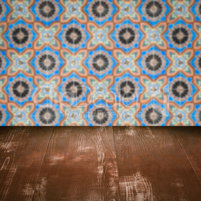 Wood table top and blur vintage ceramic tile pattern wall