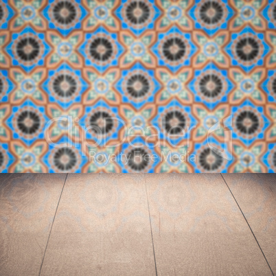 Wood table top and blur vintage ceramic tile pattern wall Wood table top and blur vintage ceramic tile pattern wall