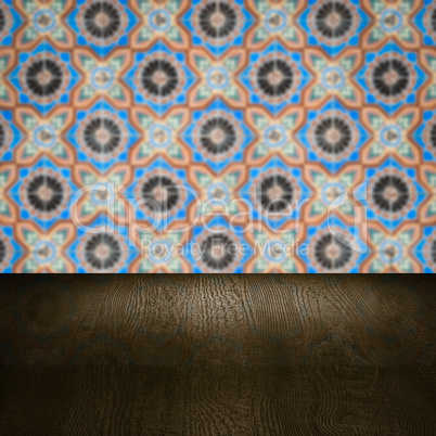 Wood table top and blur vintage ceramic tile pattern wall