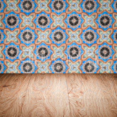 Wood table top and blur vintage ceramic tile pattern wall