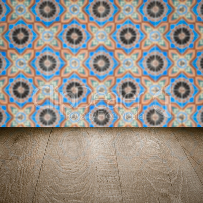 Wood table top and blur vintage ceramic tile pattern wall