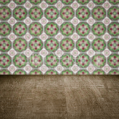 Wood table top and blur vintage ceramic tile pattern wall