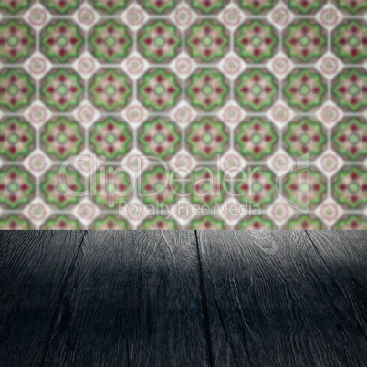 Wood table top and blur vintage ceramic tile pattern wall