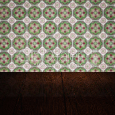 Wood table top and blur vintage ceramic tile pattern wall