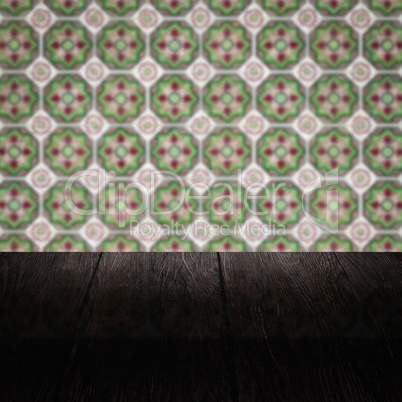 Wood table top and blur vintage ceramic tile pattern wall