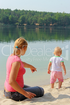 mother watches her baby at the river