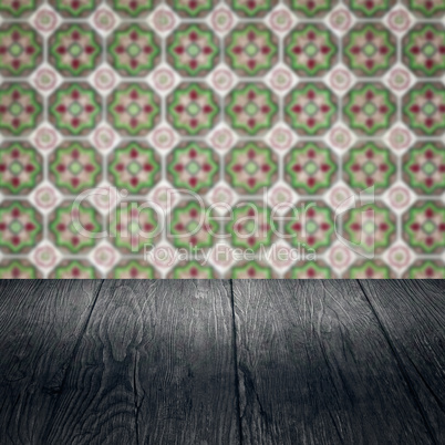 Wood table top and blur vintage ceramic tile pattern wall