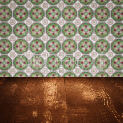 Wood table top and blur vintage ceramic tile pattern wall