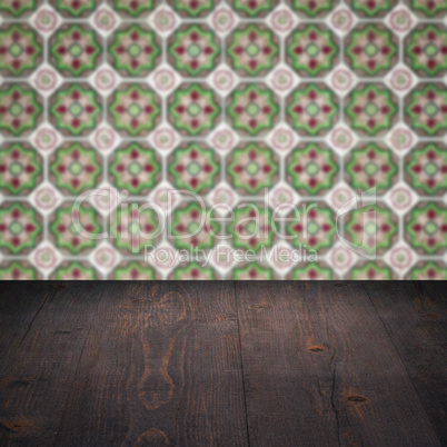 Wood table top and blur vintage ceramic tile pattern wall