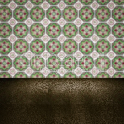 Wood table top and blur vintage ceramic tile pattern wall