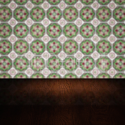 Wood table top and blur vintage ceramic tile pattern wall