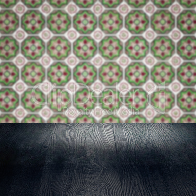 Wood table top and blur vintage ceramic tile pattern wall