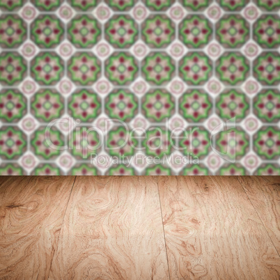 Wood table top and blur vintage ceramic tile pattern wall