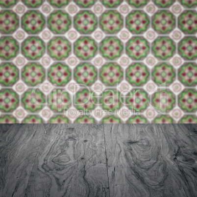 Wood table top and blur vintage ceramic tile pattern wall