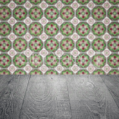 Wood table top and blur vintage ceramic tile pattern wall