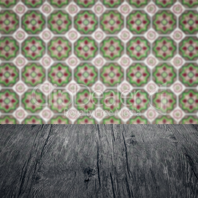 Wood table top and blur vintage ceramic tile pattern wall