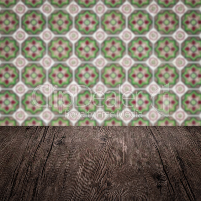 Wood table top and blur vintage ceramic tile pattern wall