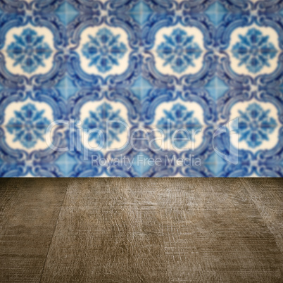 Wood table top and blur vintage ceramic tile pattern wall