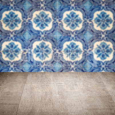 Wood table top and blur vintage ceramic tile pattern wall