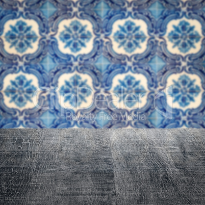 Wood table top and blur vintage ceramic tile pattern wall