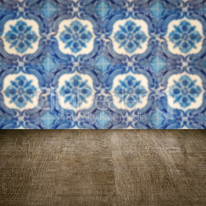 Wood table top and blur vintage ceramic tile pattern wall