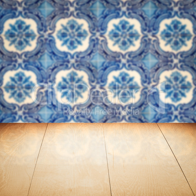 Wood table top and blur vintage ceramic tile pattern wall